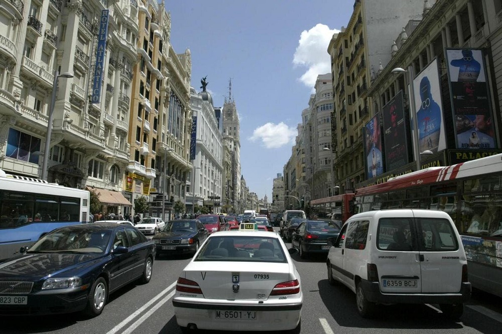 A wonderful view of cars driving in the roads of Madrid, Spain.