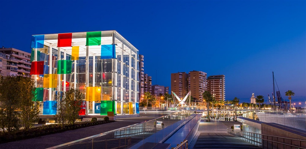 Exterior view of the Centre Pompidou Malaga, showcasing its iconic cube structure with multicolored panels.