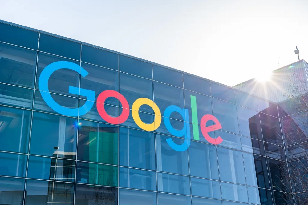 A modern, multi-story Google office building with a large Google logo displayed on the front. The building's sleek design and glass facade reflect the company's innovative spirit.