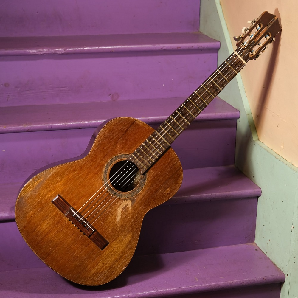 Spanish guitar on the purple floor.