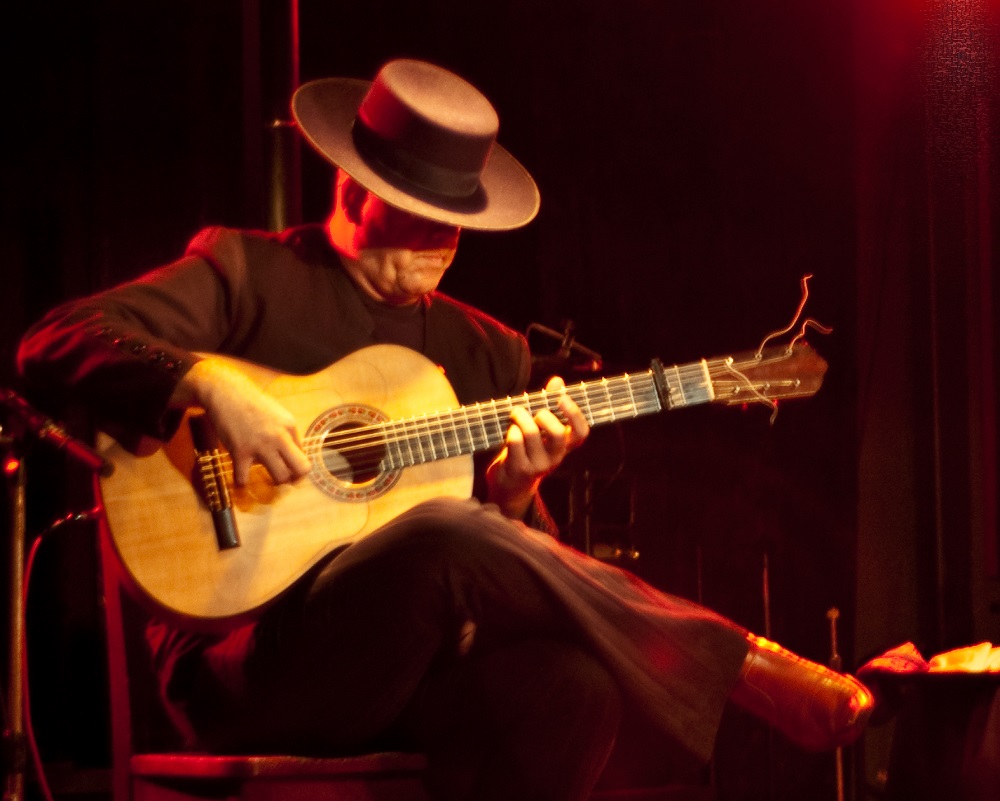 A Spanish guitar player playing flamenco music.