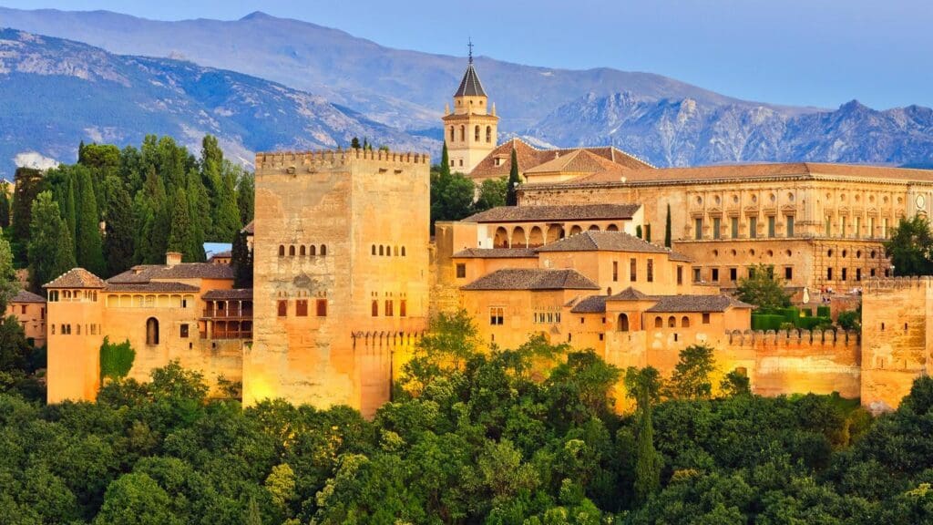Panoramic view of the Alhambra palace against the backdrop of the Sierra Nevada mountains in Granada, Spain