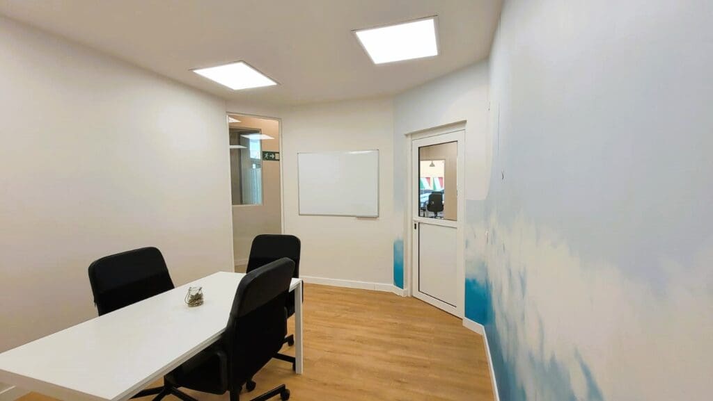 Empty classroom with a sky mural at Vamos Academy, Málaga