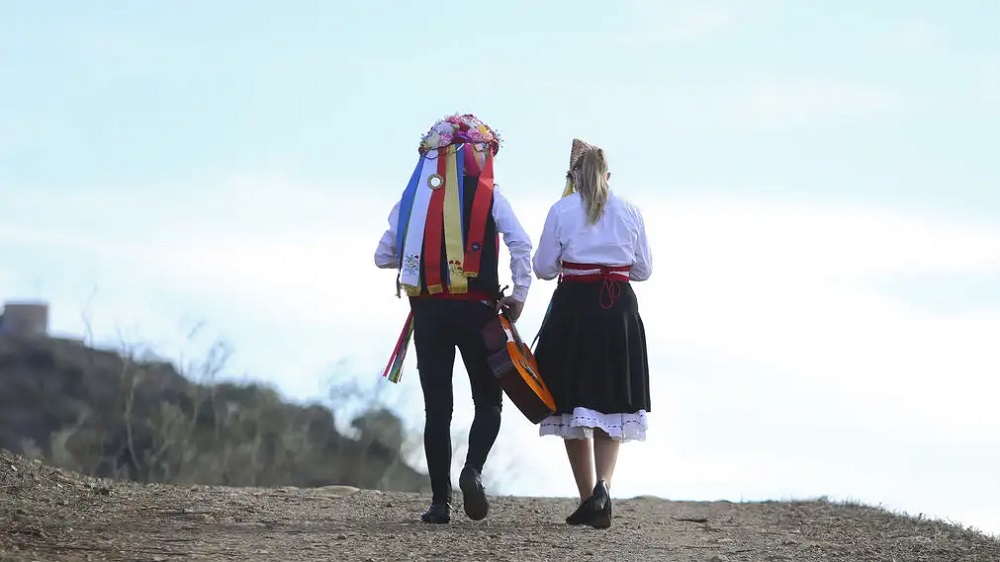 a picture of two people wearing verdiales costume. A man and a Women.